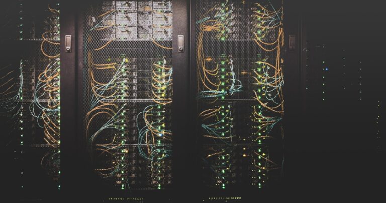 Developer documenting microservice architecture on multiple screens